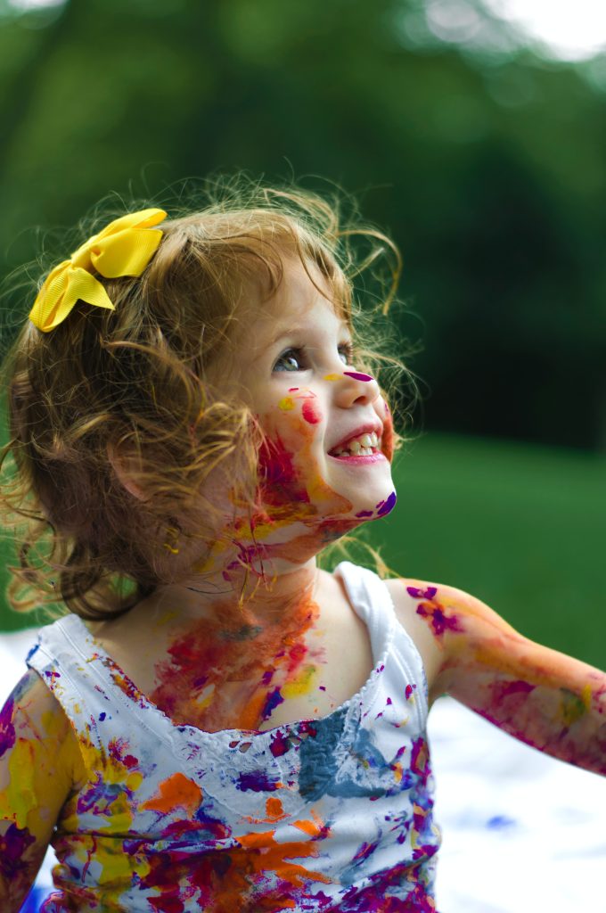 Fetiță fericită, pictată multicolor 